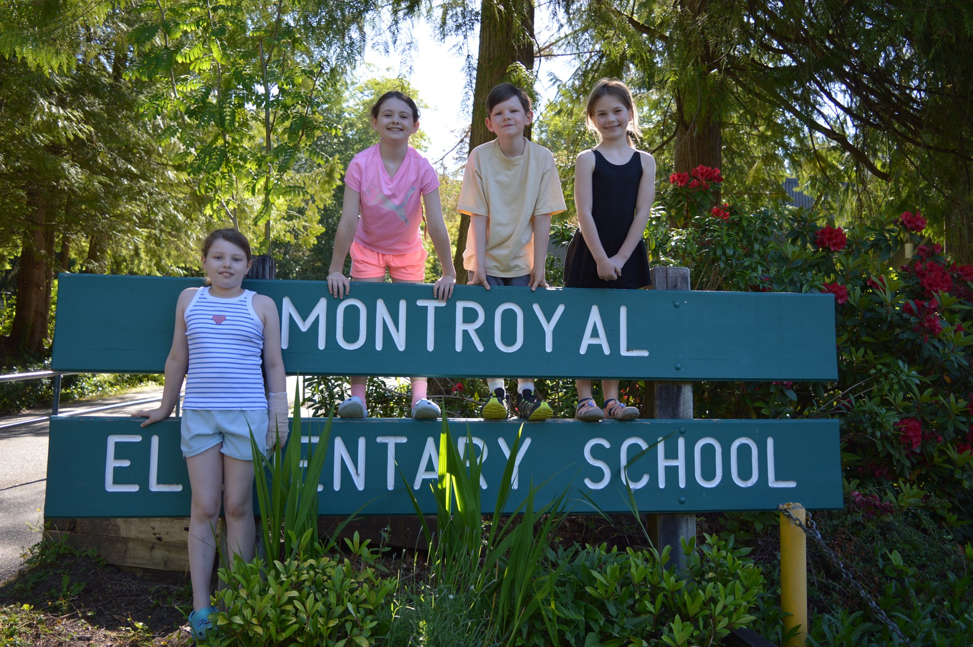 Students standing in front of sign.